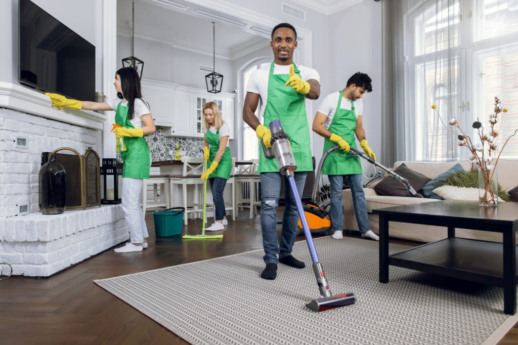 Team of house cleaners providing deep cleaning services. Professional cleaners vacuuming and dusting in Washington DC, ensuring a spotless home.