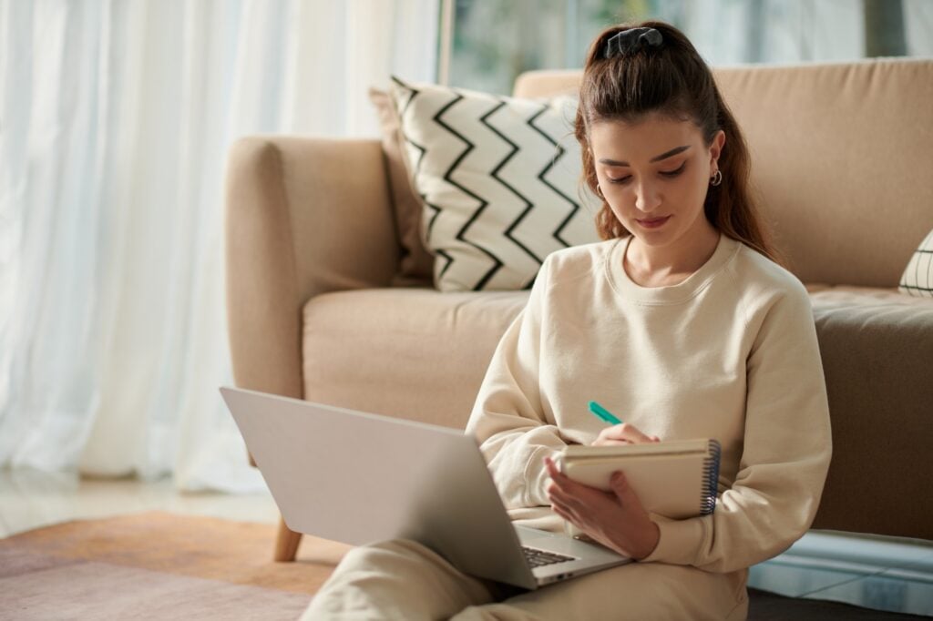 Woman in Washington DC with laptop taking notes. Online learning and education concept. Remote work and study lifestyle.