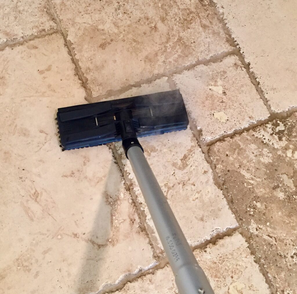 Tile and grout cleaning in Washington DC. Steam mop cleaning dirty tile floors, removing stains and grime from grout lines, leaving a sparkling surface.