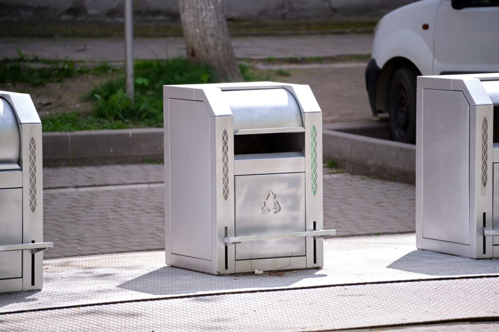 Metal recycling bins on a city street in Washington DC, promoting environmental sustainability and waste management solutions.