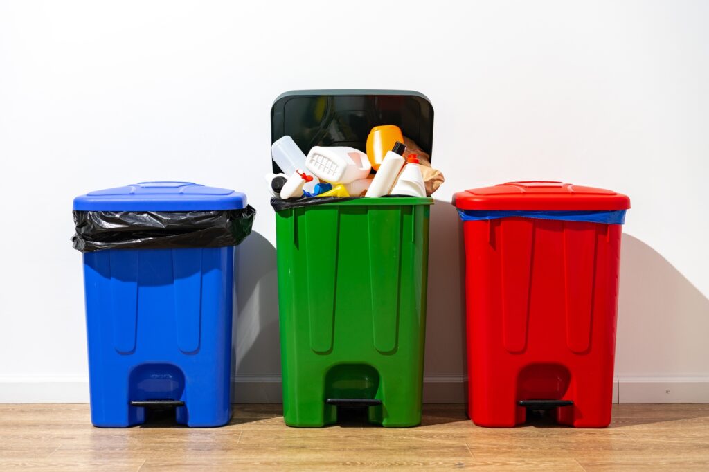 Recycling bins in Washington DC, blue, green, and red, for waste management. Trash cans for sorting recyclables, promoting environmental sustainability.