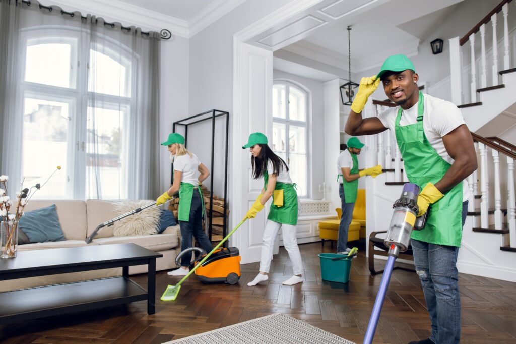Residential cleaning services team vacuuming and mopping a home. Professional cleaners in Washington DC doing house cleaning.